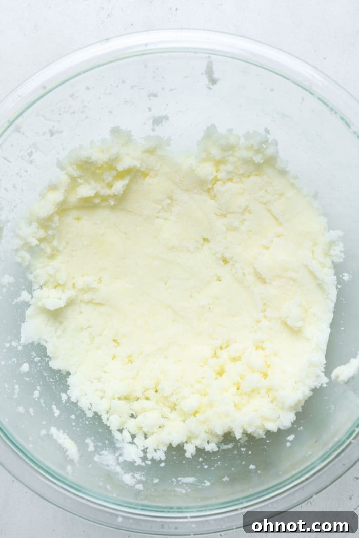 Creamed butter and sugar mixture in a light-colored mixing bowl.