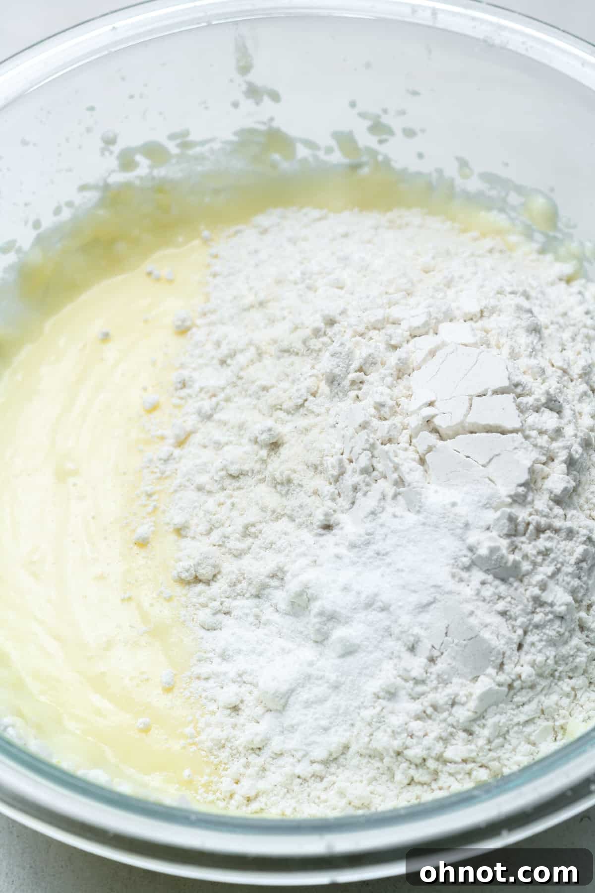 Cookie batter with dry flour added, ready to be mixed.