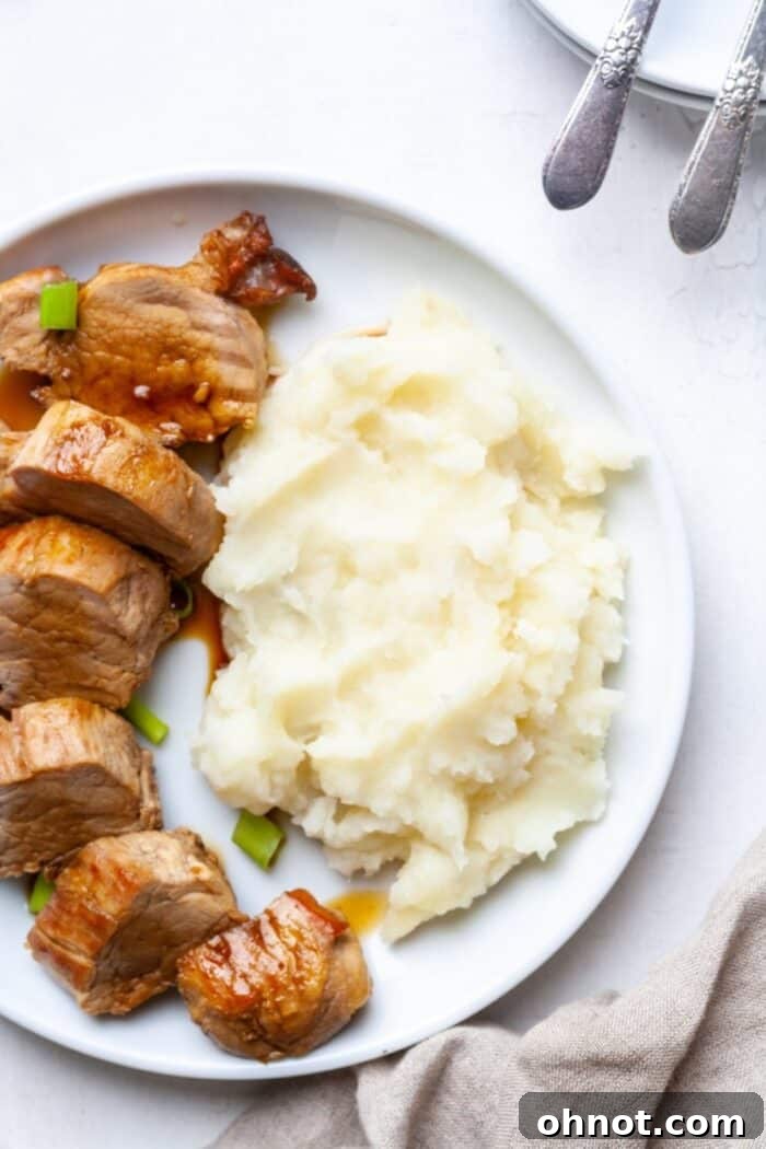 Whole30 Pork Tenderloin served alongside creamy mashed potatoes