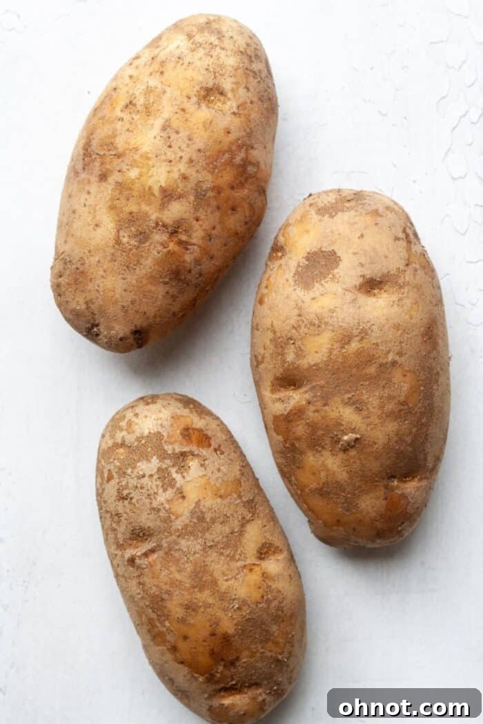 Fresh Russet potatoes on a wooden surface
