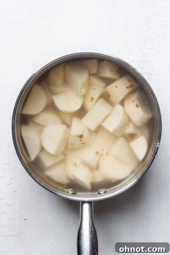 Cubed potatoes covered with water in a pot on the stovetop