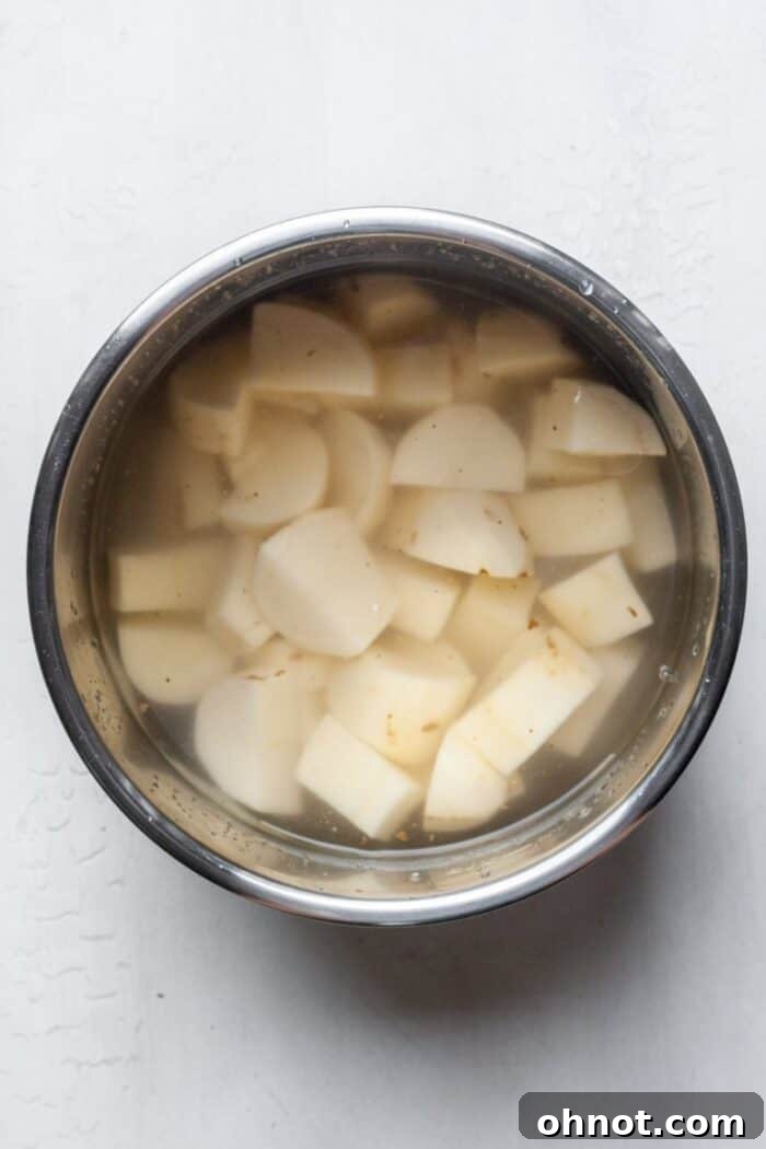 Cubed potatoes covered with water in an Instant Pot