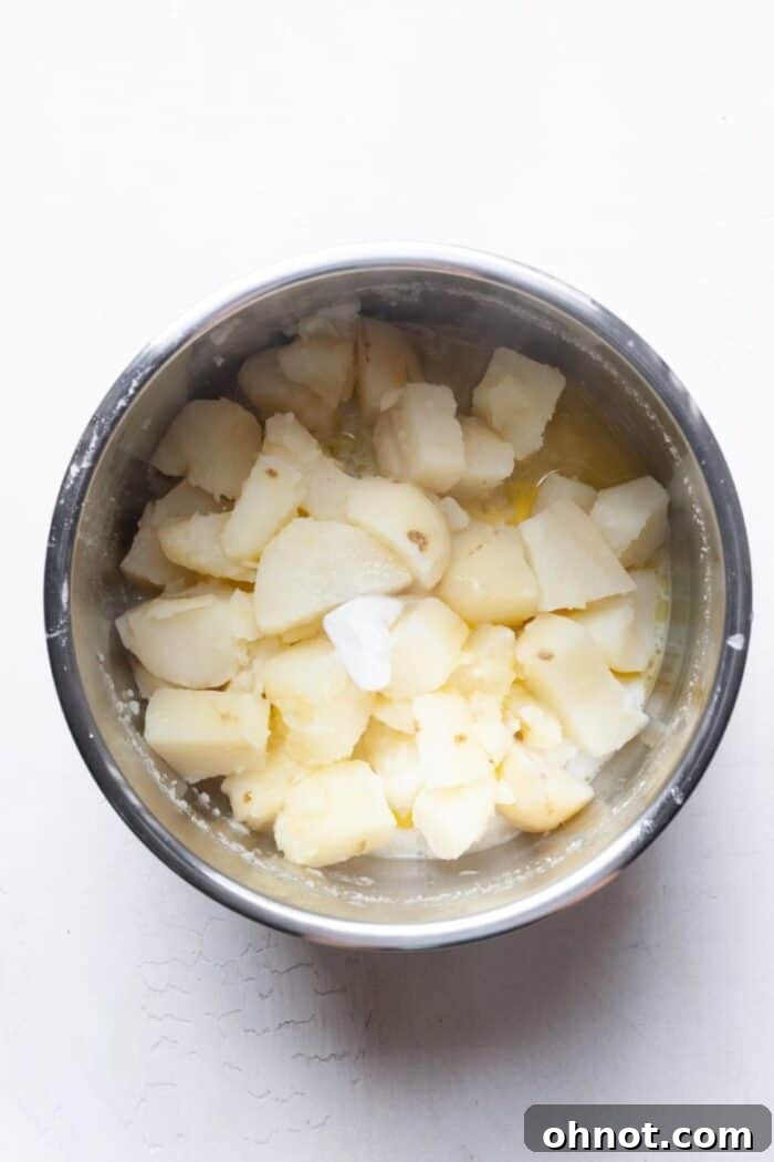 Drained potatoes with flavorings added in the Instant Pot