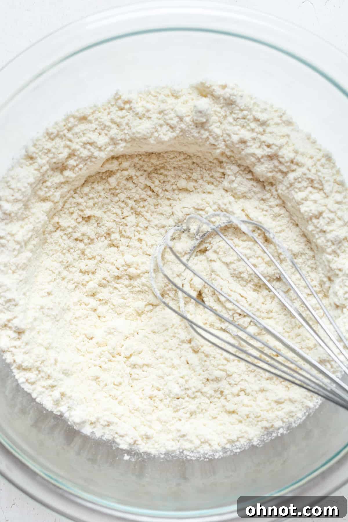 Whisked gluten-free flour and sugar in a bowl.
