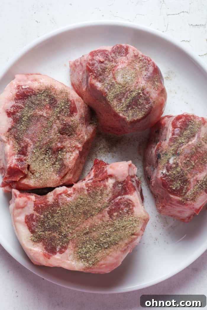 Seasoned oxtails on a cutting board.