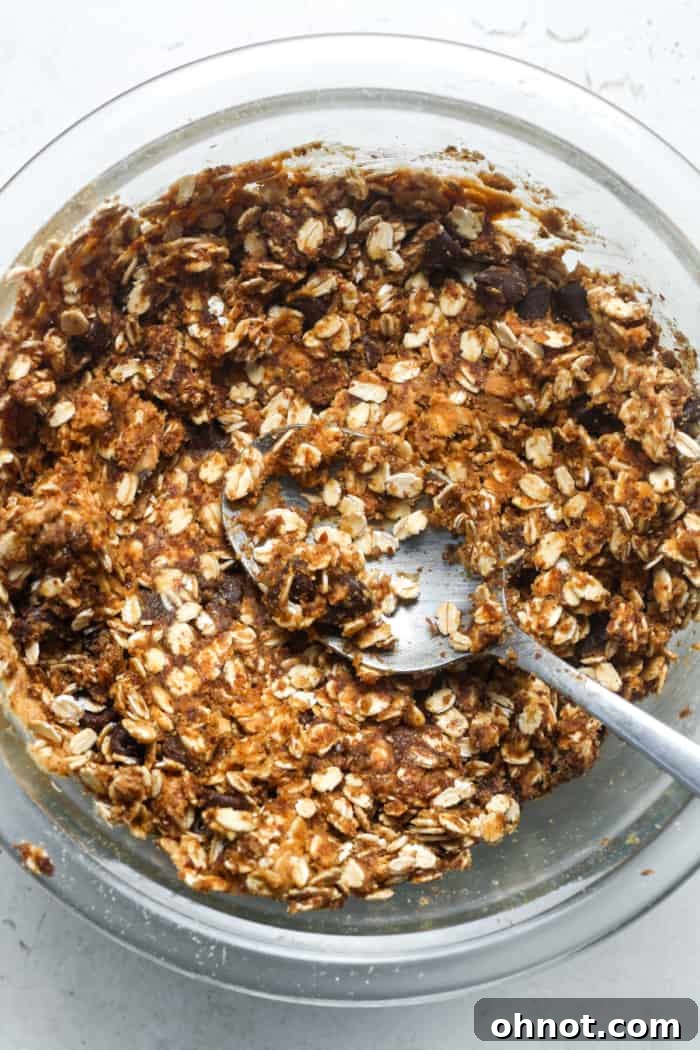Well-mixed oatmeal and peanut butter mixture in a bowl, ready for rolling into energy balls.
