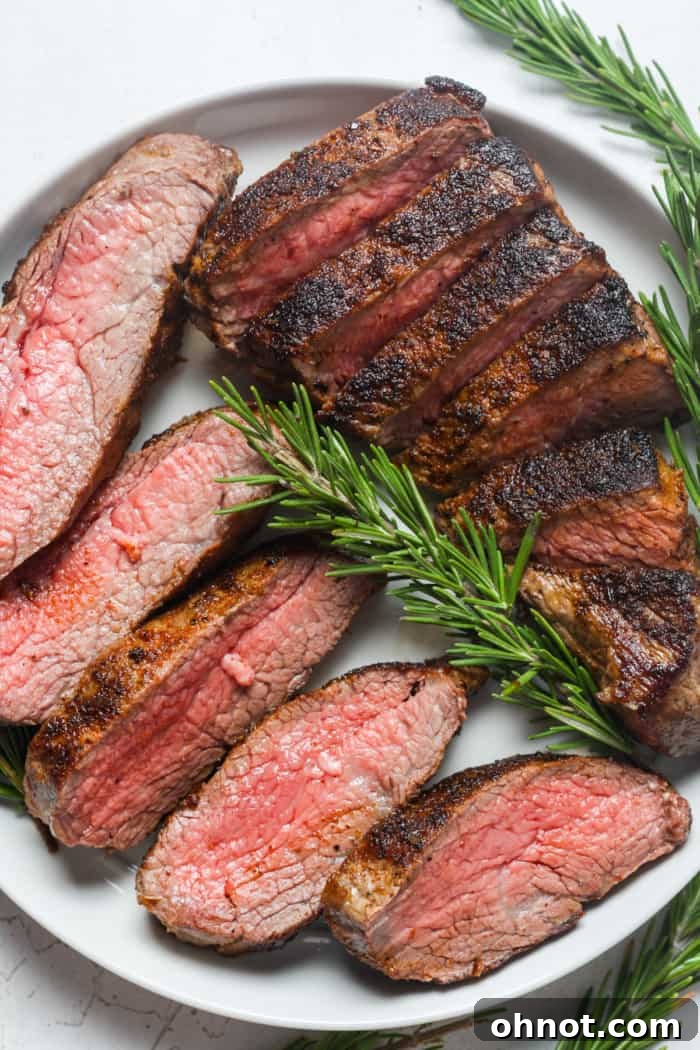 Sliced steak with rosemary.