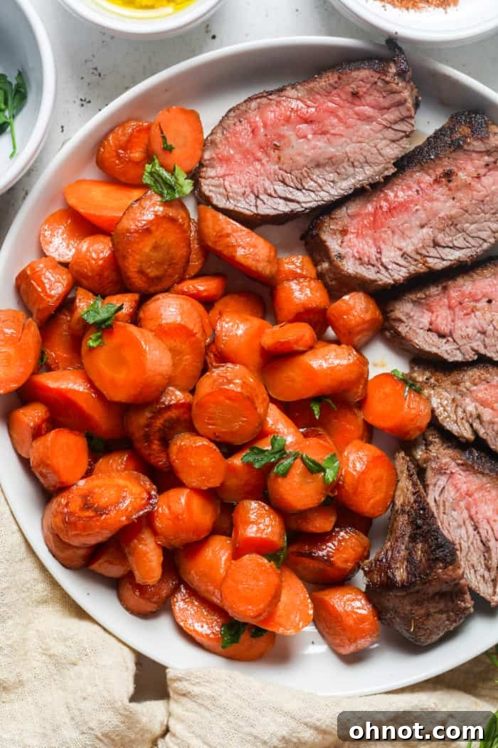 Sauteed carrots served alongside a steak and other vegetables, illustrating a perfect meal pairing.