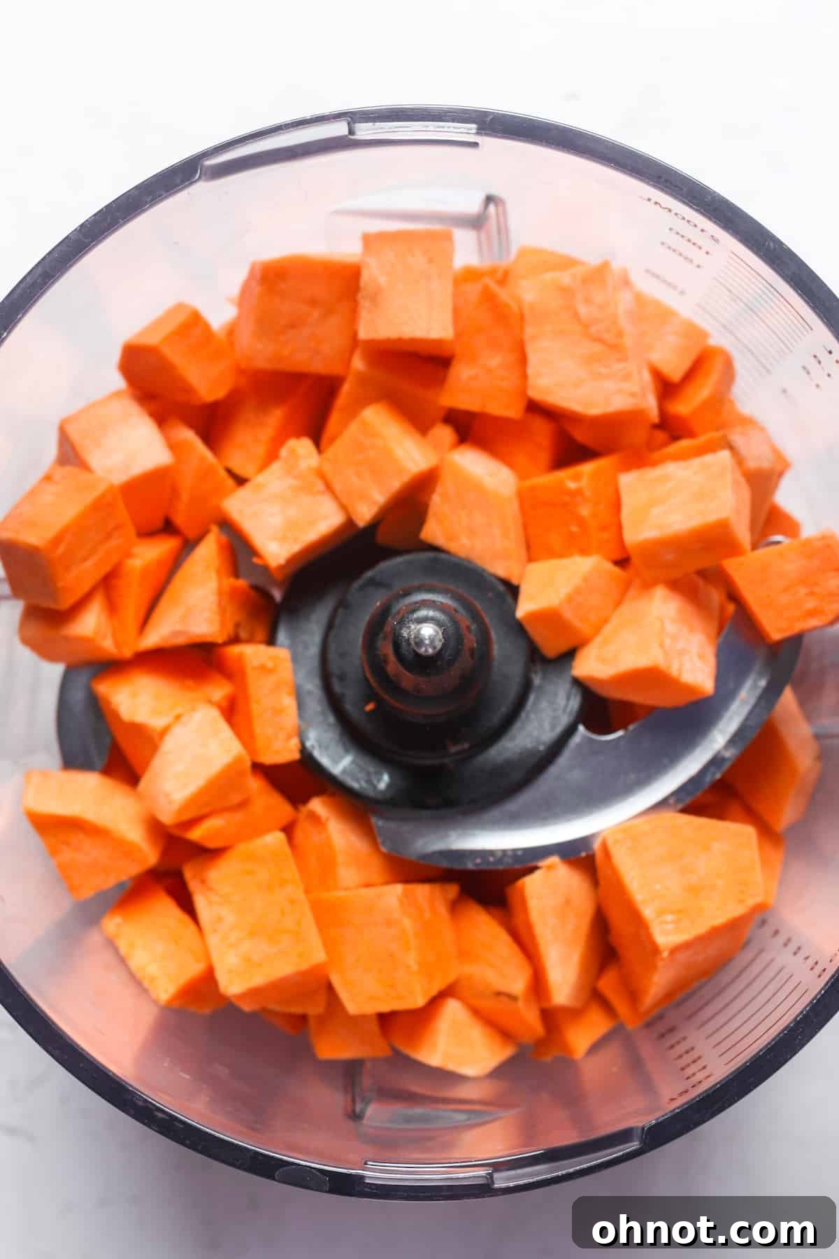 Diced sweet potatoes in food processor.