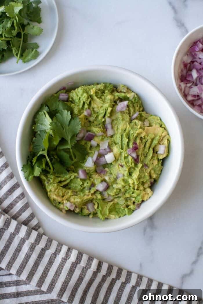 AIP guacamole in white bowl with red onions