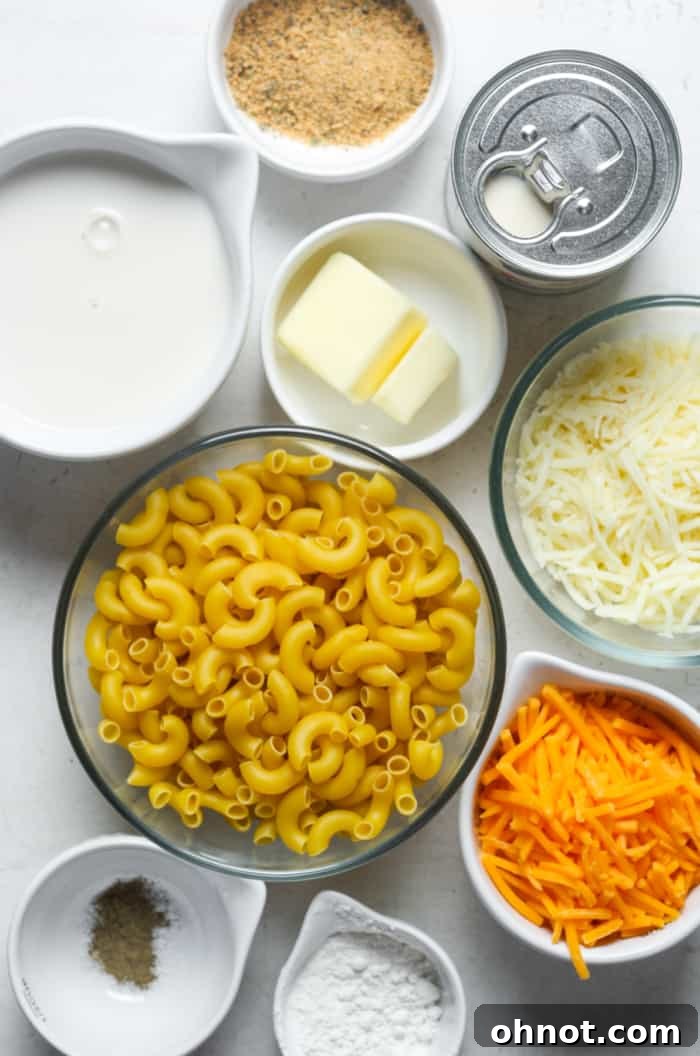 A vibrant selection of ingredients for Southern mac and cheese laid out on a wooden surface, ready for preparation.