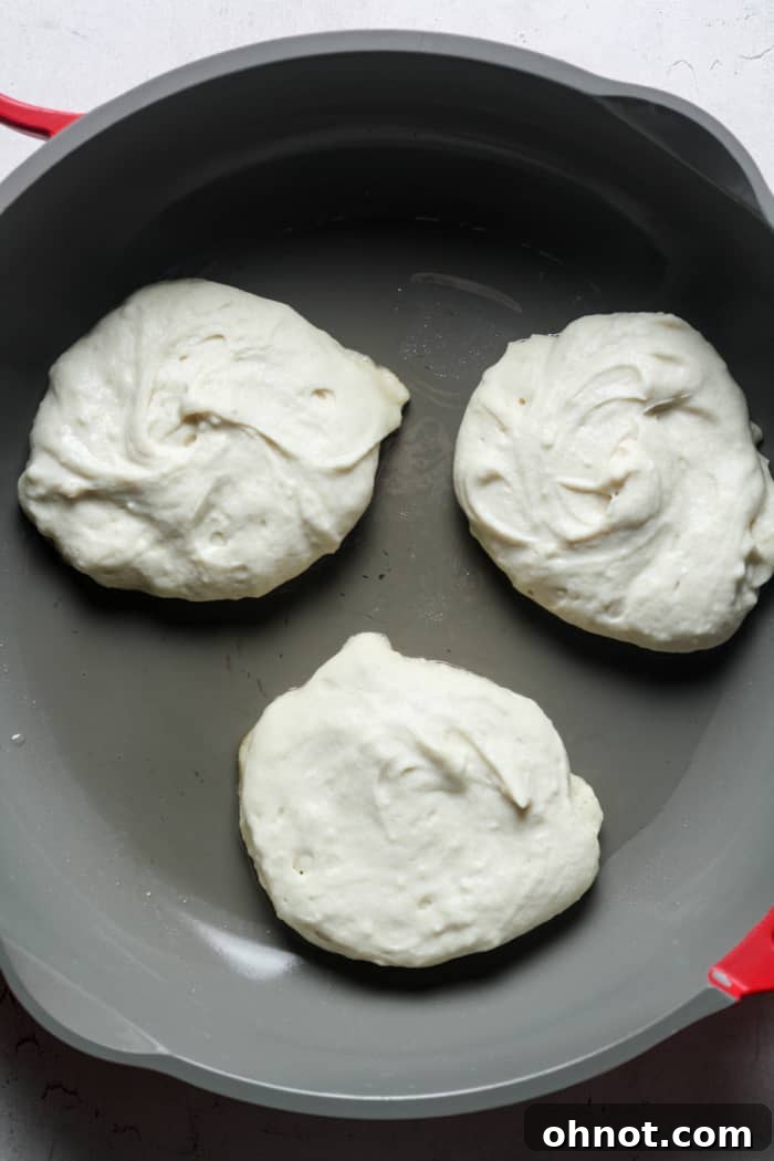 Pancake batter cooking in a pan.
