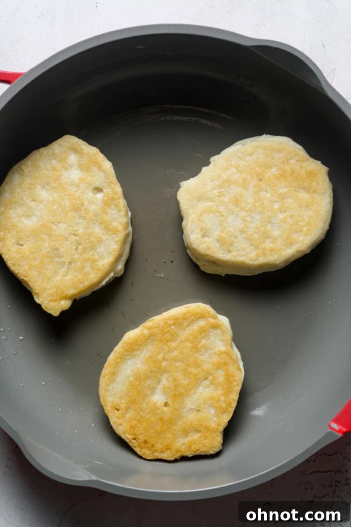 Golden fluffy vegan pancakes on a skillet.