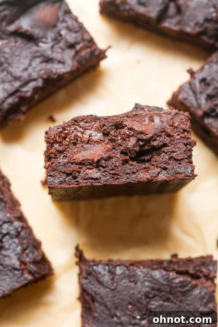 Deliciously gooey Greek yogurt brownies stacked on a plate, ready to be enjoyed.