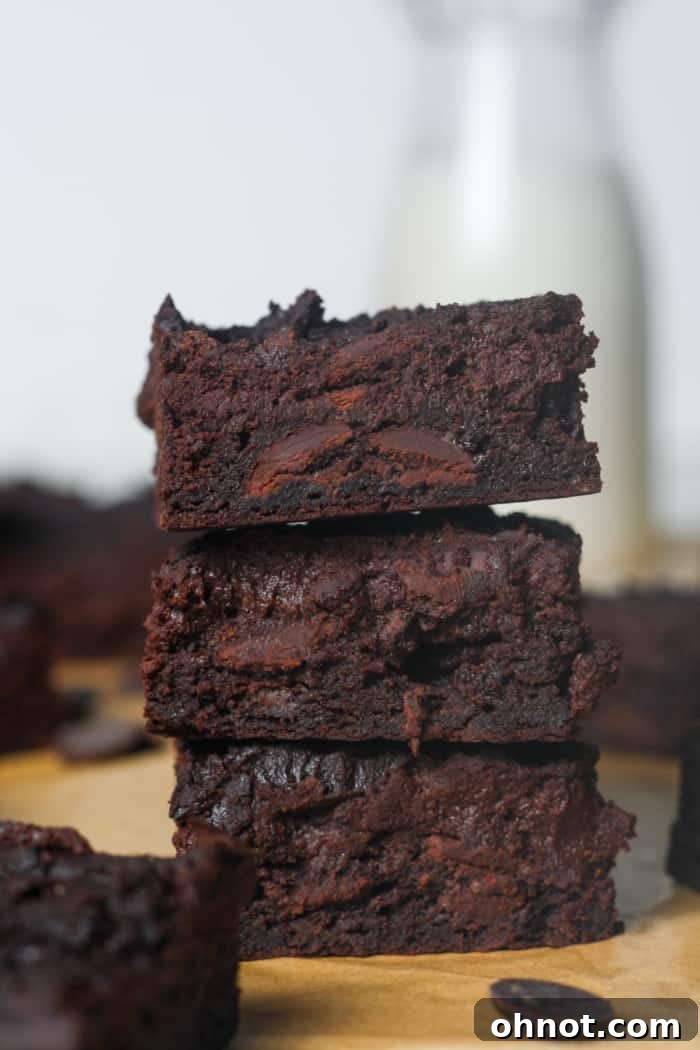 A close-up shot of individual dark chocolate yogurt brownie bars, highlighting their rich color and inviting texture.