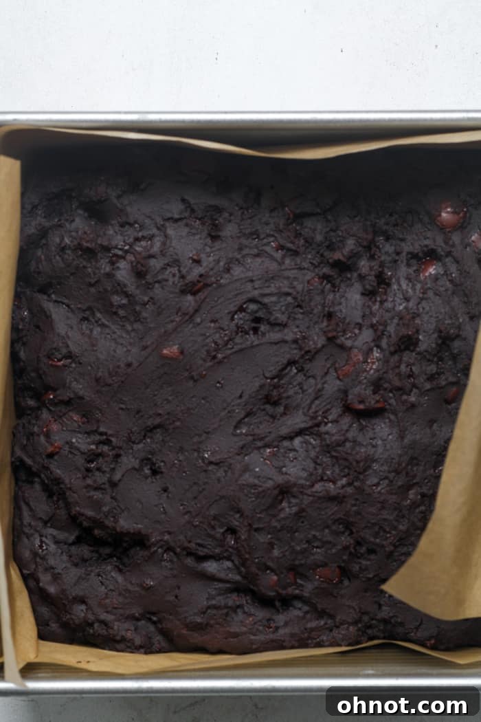 Freshly baked Greek yogurt brownies in the pan, showing their rich, dark brown color and slightly soft texture.