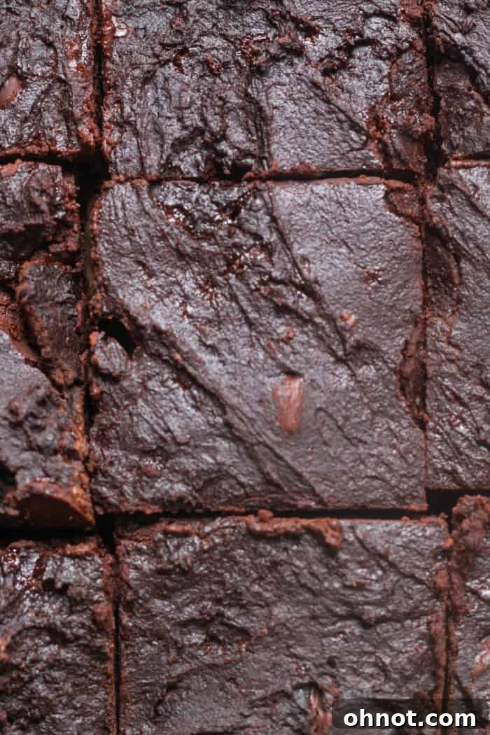 Perfectly sliced Greek yogurt brownies, revealing their rich, dark chocolate interior and fudgy texture.