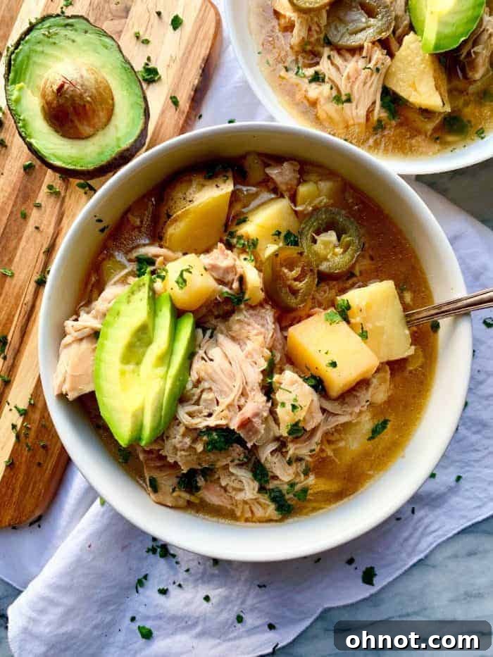 Creamy Whole30 White Chicken Chili topped with avocado