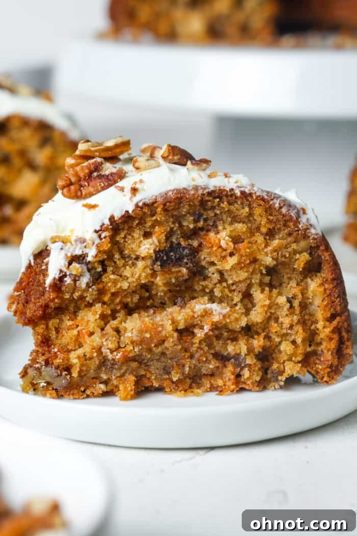 A beautifully frosted gluten-free carrot cake, moist and tender, garnished with pecans.
