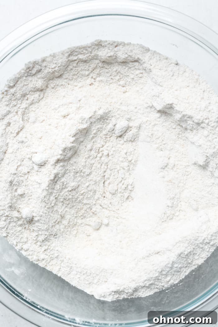 Dry cake ingredients sifted together in a bowl.