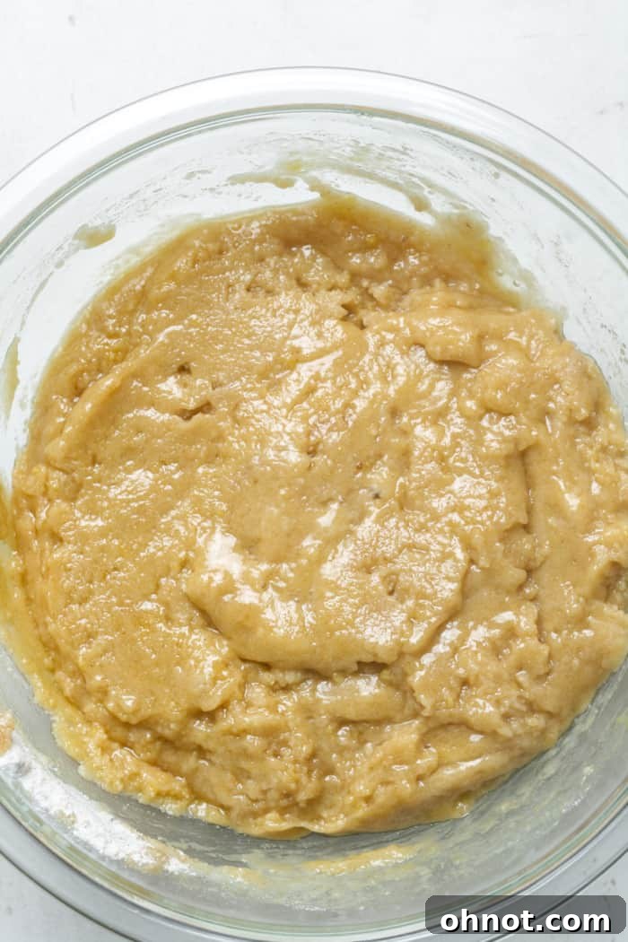 Wet cake batter mixed in a bowl.