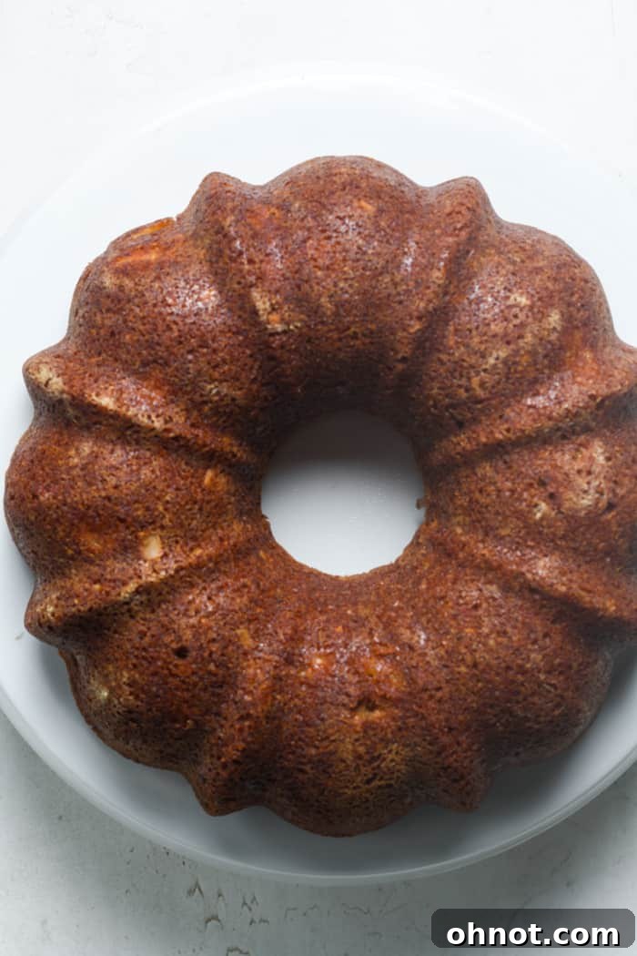 A cooled Bundt cake on a wire rack, ready for frosting.