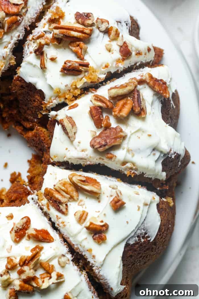 A slice of healthy baked carrot cake with pecans.