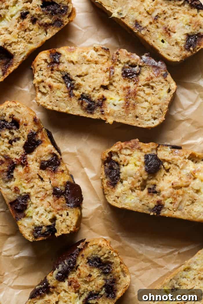Healthy banana bread, perfectly sliced on a wooden board.