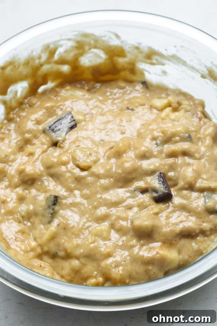 Thick bread batter with chocolate chips being folded in.