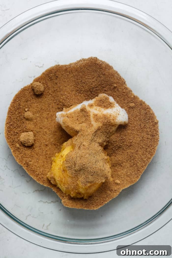 Coconut sugar, coconut oil, and ghee being creamed in a mixing bowl.