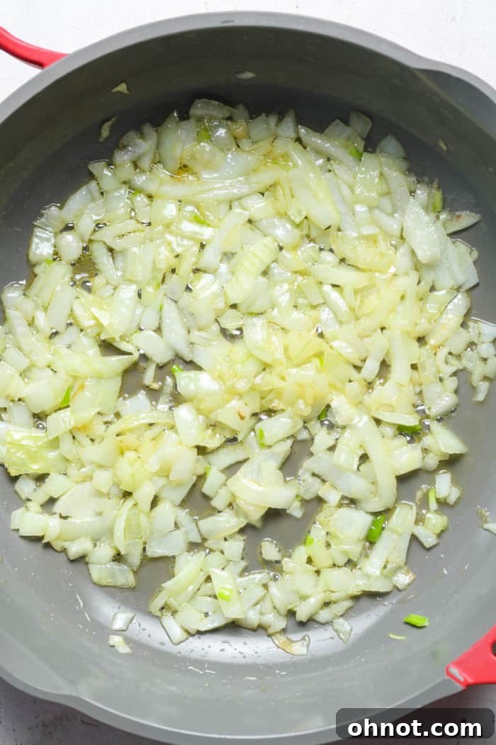 Softened and lightly browned onions in a pan, seasoned with sea salt.