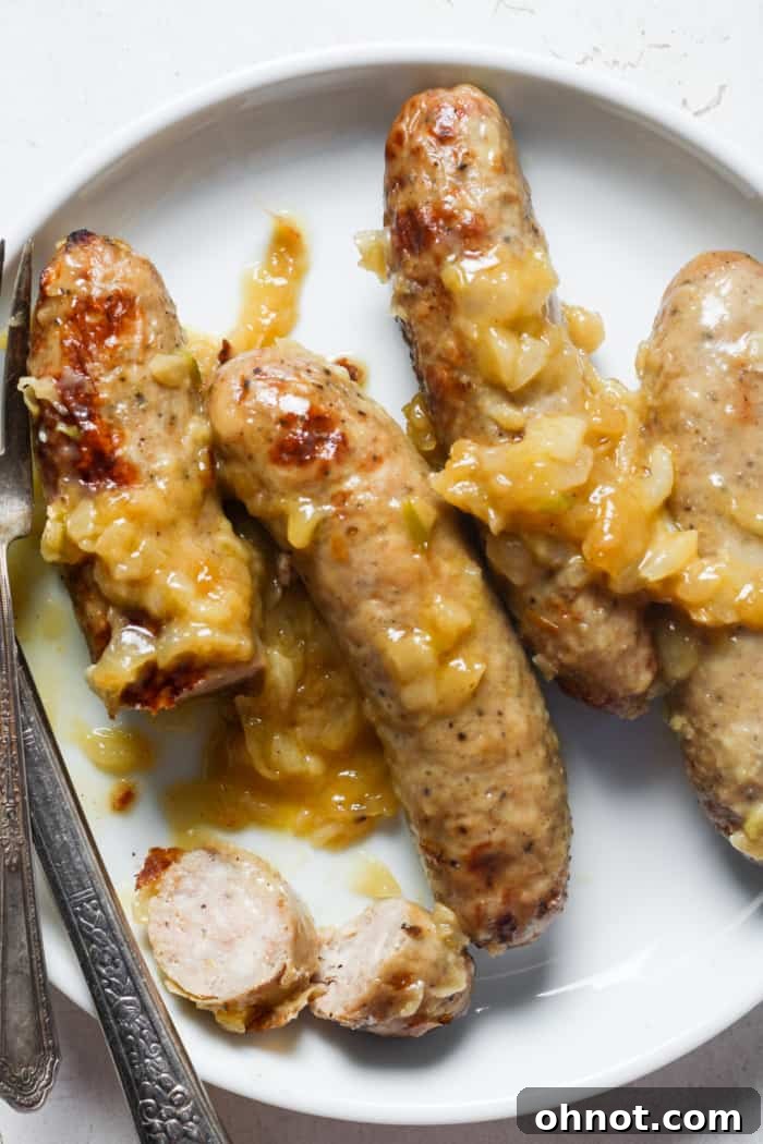 Perfectly cooked bratwurst with soft, sweet caramelized onions.