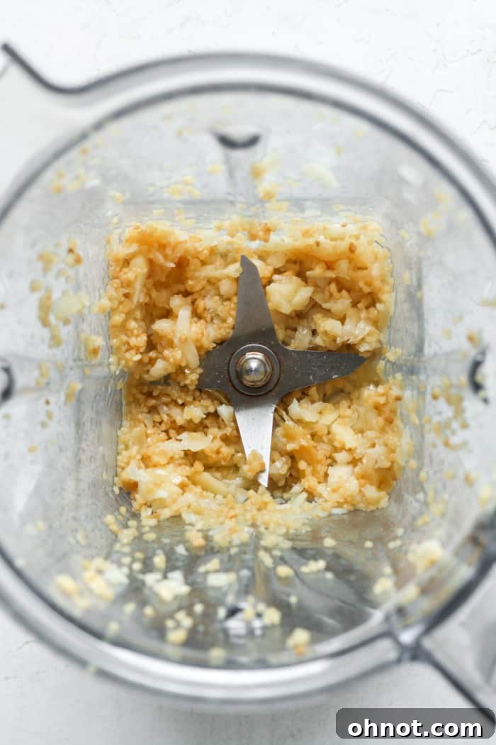 Finished minced garlic sitting in the blender bowl.