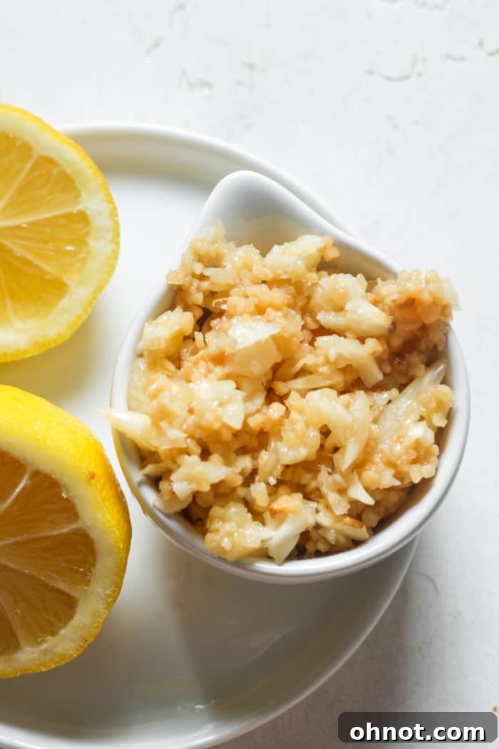 Arrangement of various spices and a lemon wedge, often used in recipes featuring minced garlic, symbolizing versatility.