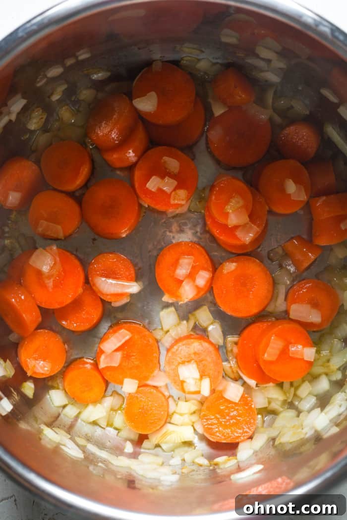 Carrots and onions sautéing in the Instant Pot.