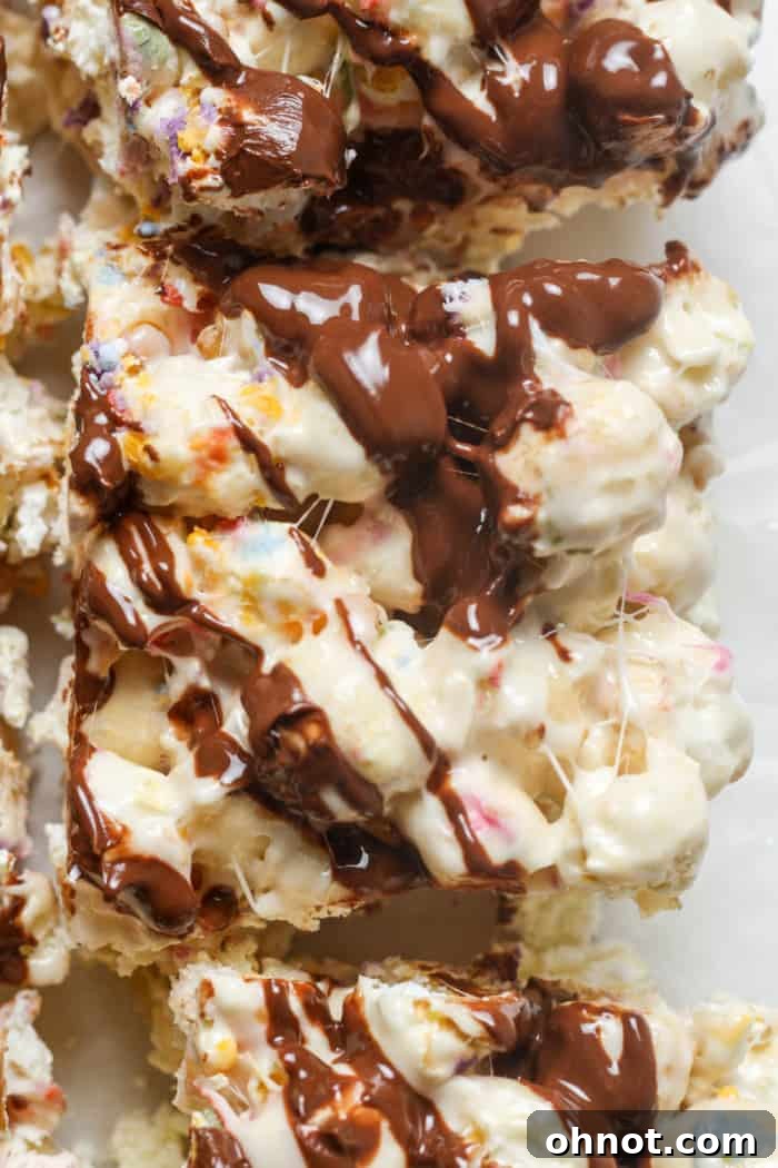 A vibrant display of popcorn bars, featuring chocolate drizzle and colorful sprinkles.