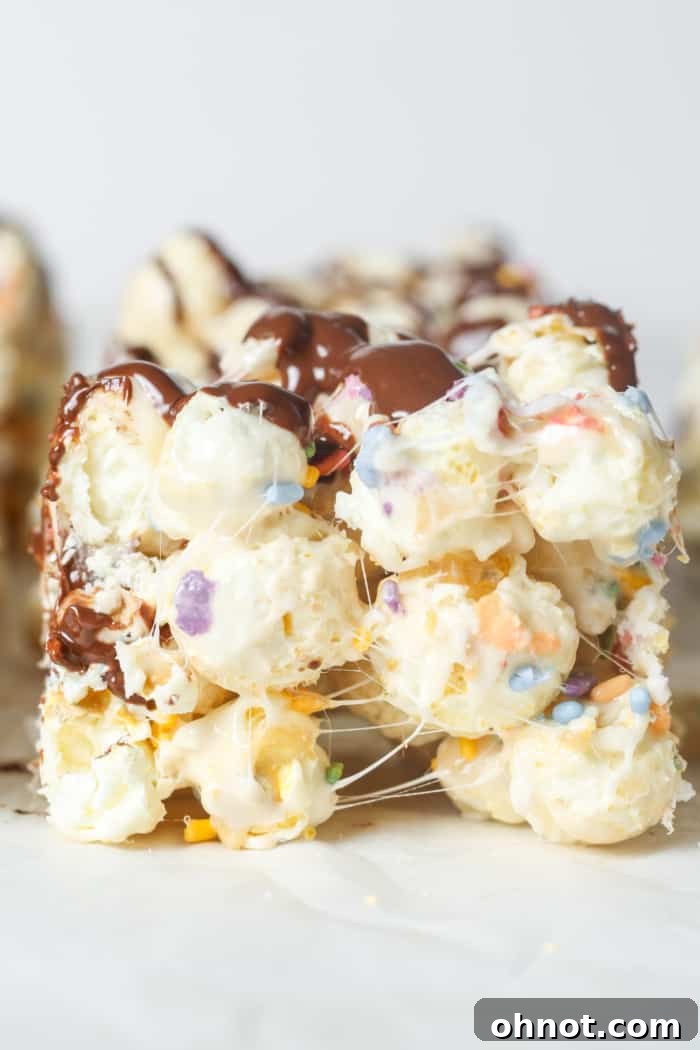 Perfectly sliced popcorn bars with chocolate and sprinkles, ready for sharing.
