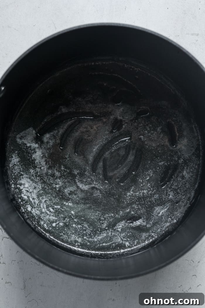 Melted butter shimmering in a Dutch oven over low heat.