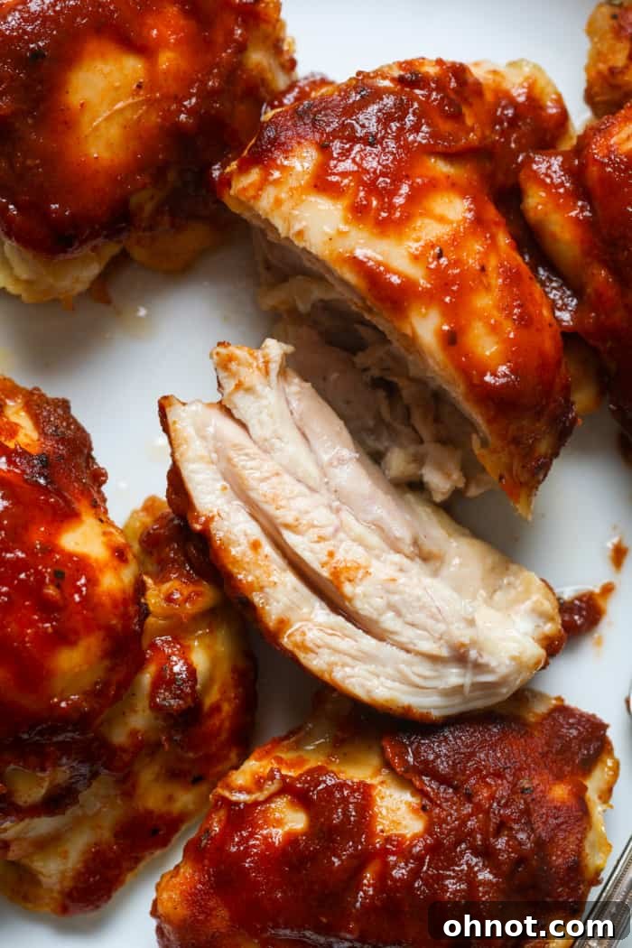 Perfectly cooked BBQ chicken thighs on a serving platter.
