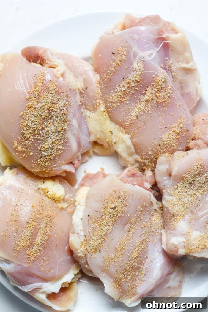 Chicken thighs generously seasoned with spices.