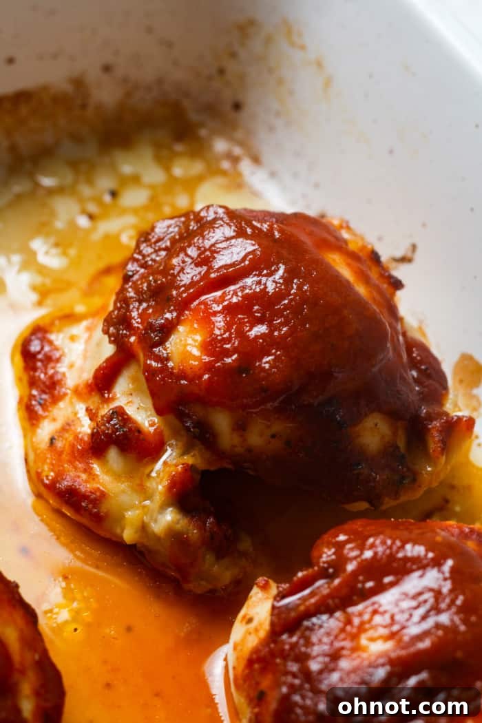 Saucy chicken thighs baking in the pan.