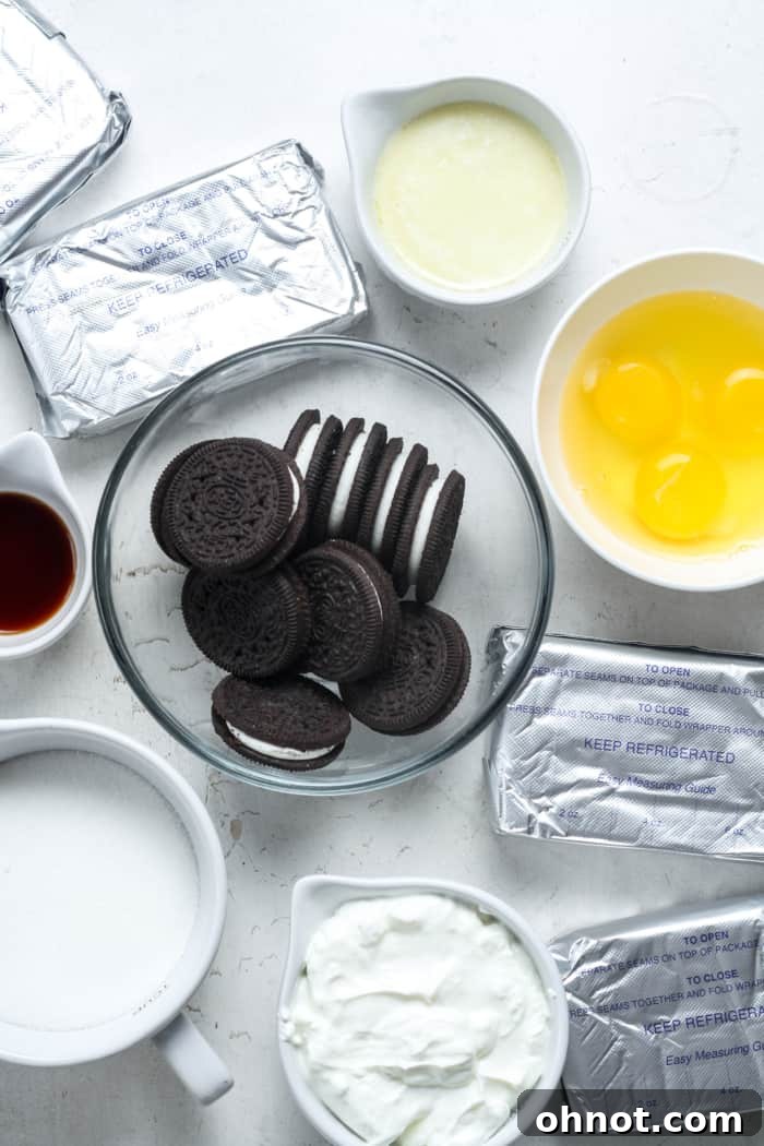 All the fresh, high-quality ingredients laid out for making the perfect Oreo cheesecake, including Oreos, cream cheese, butter, and chocolate chips.