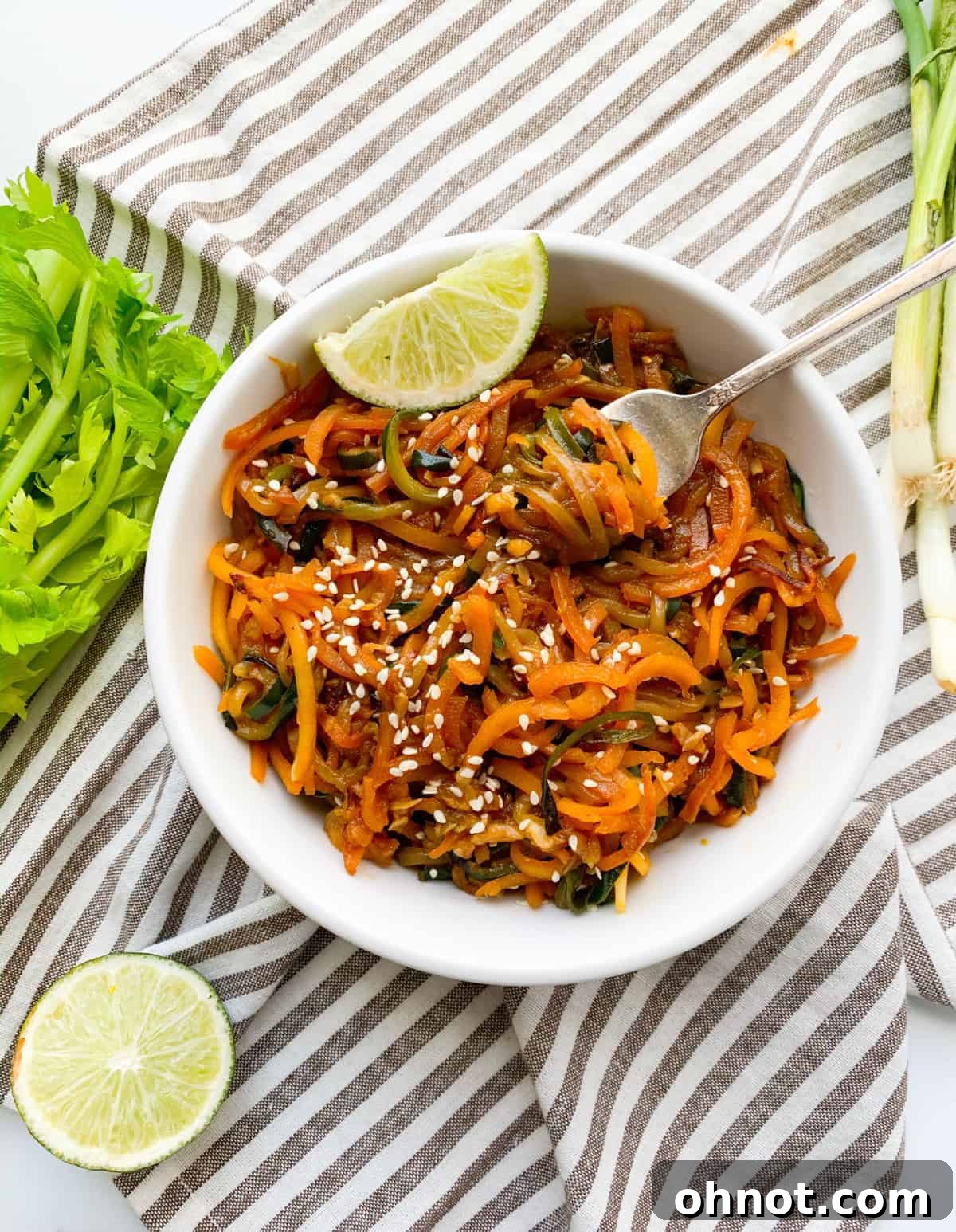 Delicious Whole30 Vegan Asian Sesame Noodles dish garnished with sesame seeds and lime