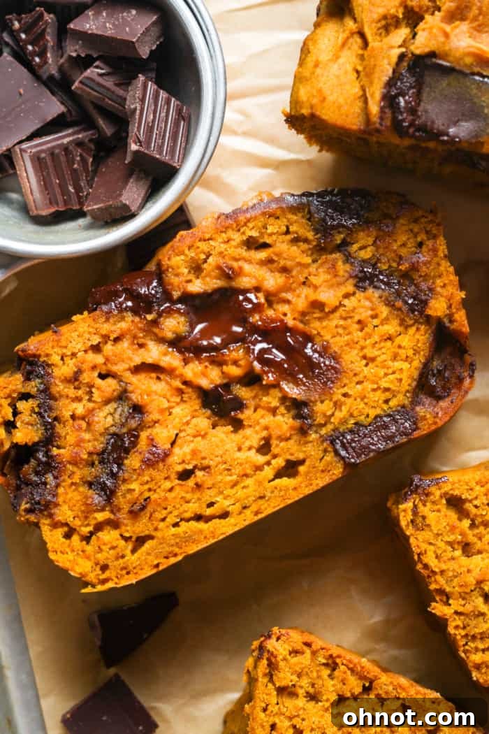 Sliced baked pumpkin bread on a cutting board.