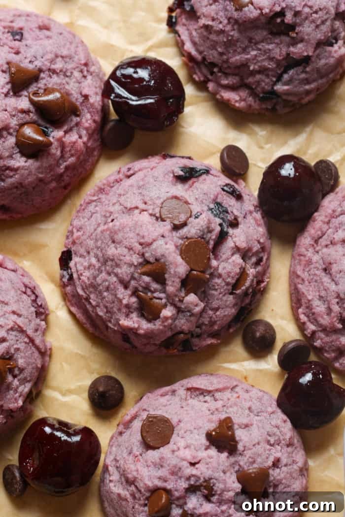 Stack of freshly baked cookies with cherries.