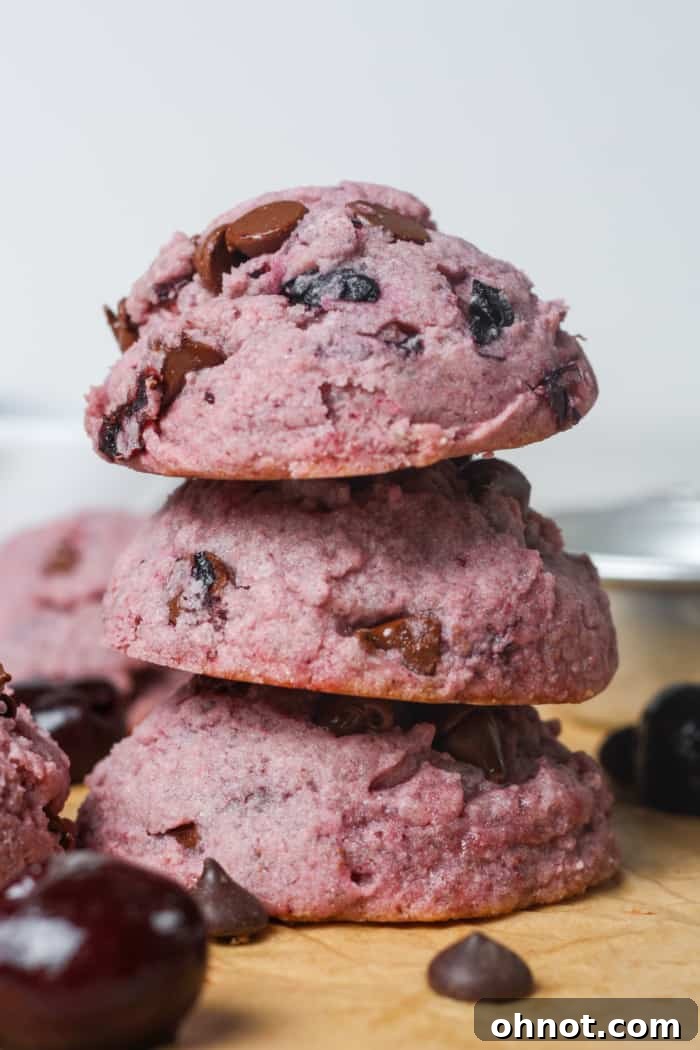 Stack of vibrant purple baked goods, cherry cookies.