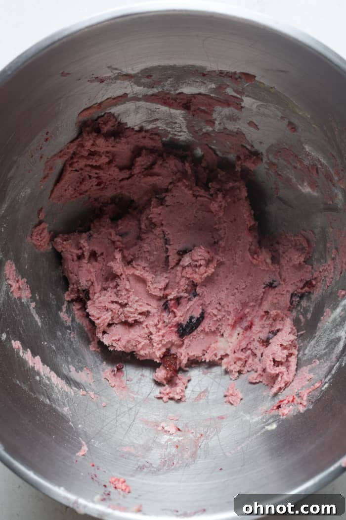 Cherry cookie dough mixed with dry ingredients.