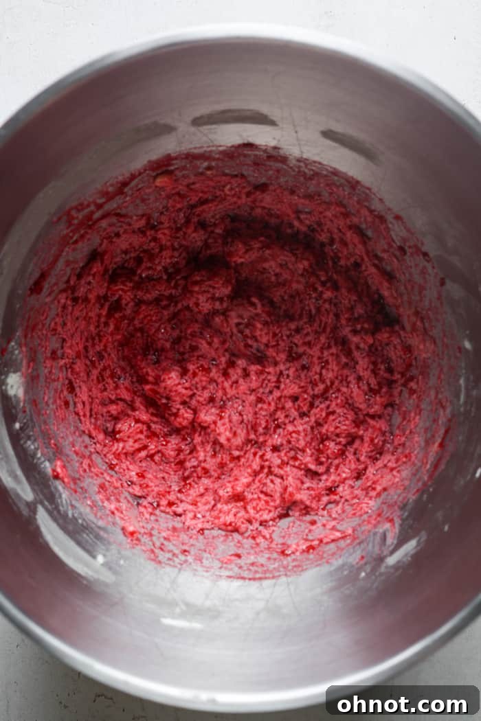 Runny pink batter after raspberries are mixed in.