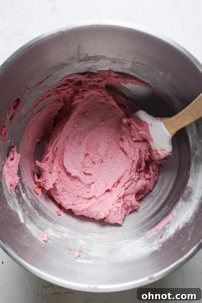 Pink cookie dough after all dry ingredients are mixed.