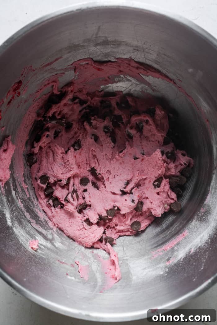 Chocolate chip raspberry cookie dough in a bowl.